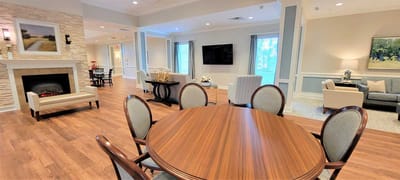 Bright common area with comfortable seating and a dining table