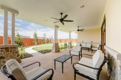 Covered outdoor seating area with nearby garden