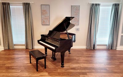A grand piano in a bright common area