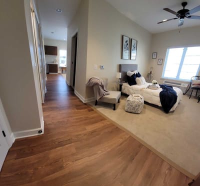 Interior view of a resident room with bed and decor