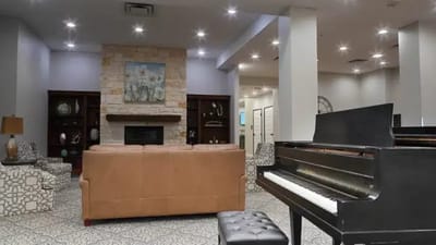 Common area in a senior living facility with a piano