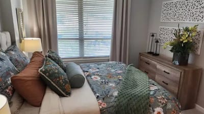 Well-decorated private resident room with floral bedding