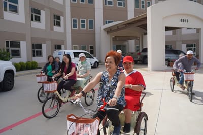 Residents enjoying a bike ride outside the facility