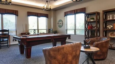 Interior view of a common area with seating and pool table