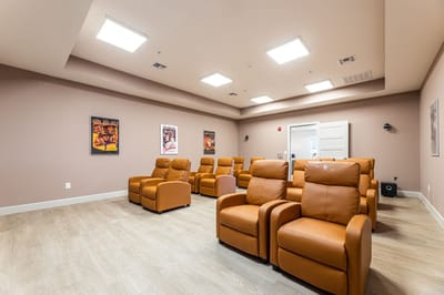 Common area with reclining chairs and movie posters