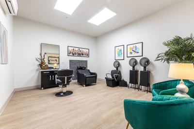 Interior view of a hair salon area with chairs and decor