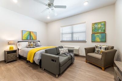 Cozy private resident room with bed and seating area