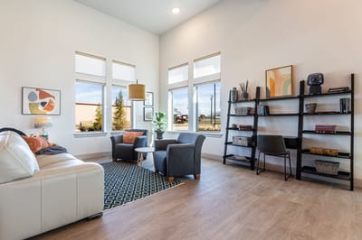 Bright common area with seating and shelves