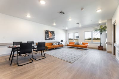 Bright common area with seating and windows.