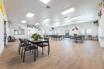Bright common area with tables and chairs