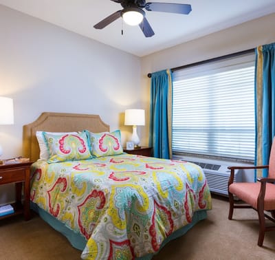 Cozy resident room with a colorful bedspread