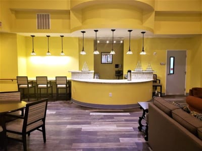 Interior common area with a yellow color scheme and bar seating