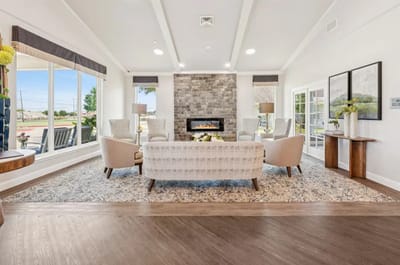 Bright common area with comfortable seating and a fireplace