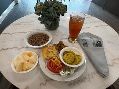 A dining table with food and drinks prepared for residents