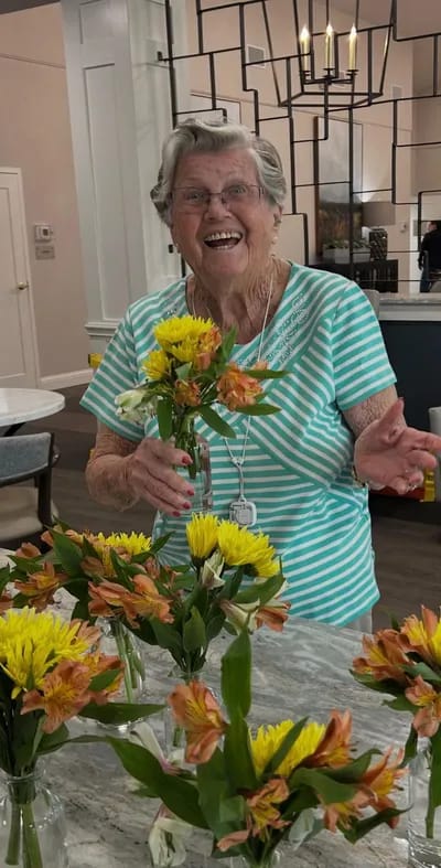 Resident arranging flowers in the common area