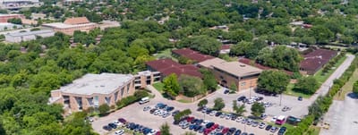 Aerial view of The Villages of Dallas campus with green surroundings