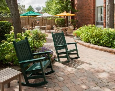 Inviting outdoor seating area with rocking chairs and greenery