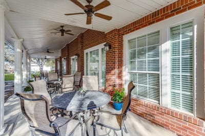 Covered patio area with seating and plants
