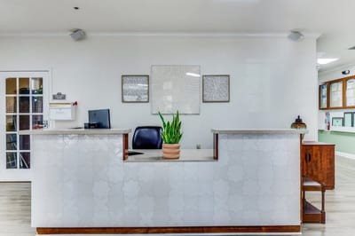 Bright reception area with plants and modern decor