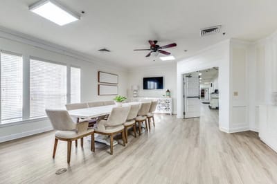 Bright common area with a dining table and chairs