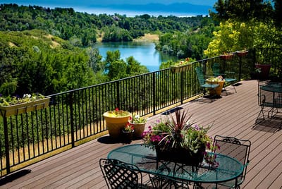 Outdoor patio with flowers overlooking a scenic view