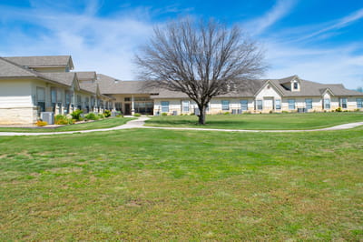 Exterior view of the facility with landscaped grounds