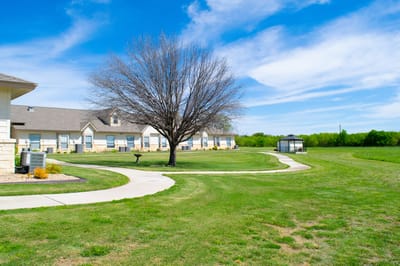 Outdoor landscaped space with a pathway and gazebo
