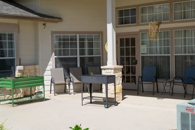 Outdoor patio area with seating and greenery