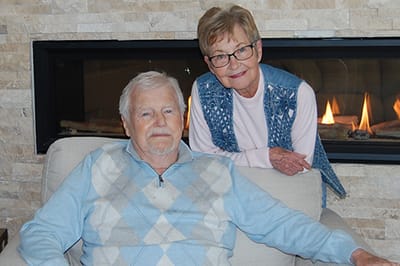 Two residents posing in a cozy interior setting