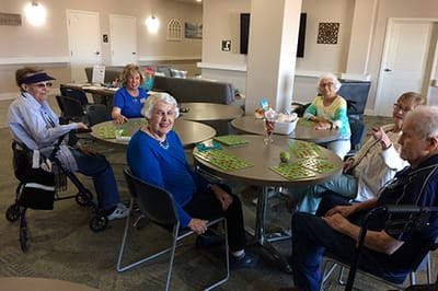 Residents enjoying bingo in a common area