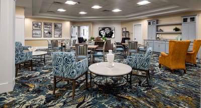 Common area with seating and decor in a senior living facility