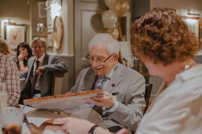 Residents enjoying a celebration together at a dining table