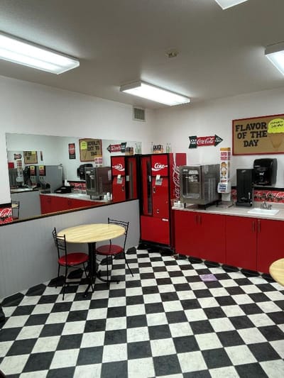 Interior view of a kitchen with coffee machines and vending