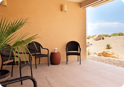 Outdoor seating area with chairs and desert landscaping