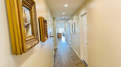 Hallway with framed artwork and doors