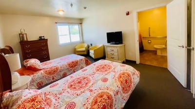Comfortable resident room with two beds and furnishings