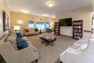 Bright and inviting common area with seating and bookshelves