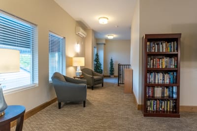 A cozy common area with bookshelves and seating