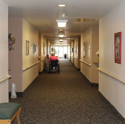Interior hallway with residents and staff