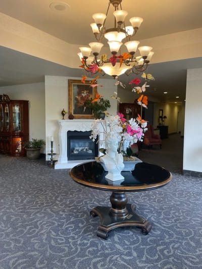 Interior view of a common area with a chandelier and floral decorations