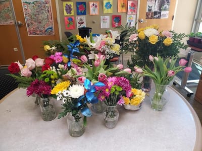 Colorful flower arrangements on a table in an activity room