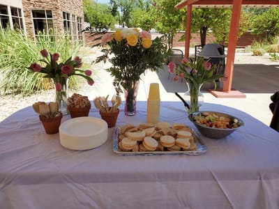 Table set up with snacks and flowers outdoors