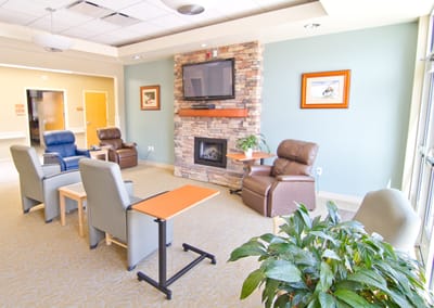 Bright interior common area with seating and a fireplace