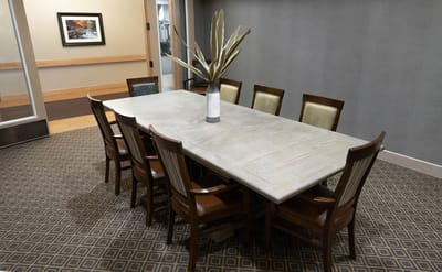 Dining table set in a common area with chairs