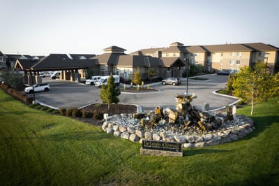 Exterior view of Cascades at Riverwalk with landscaped entrance