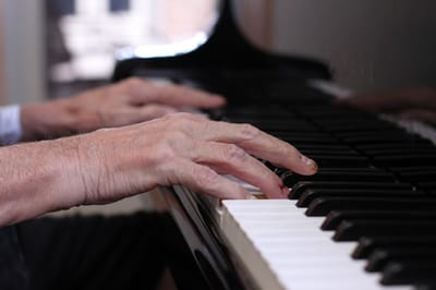 Close-up of hands playing a piano