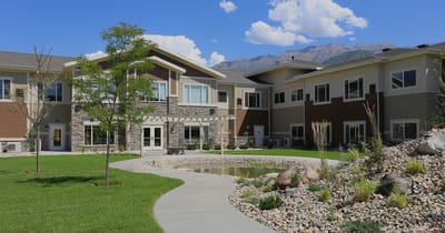 Exterior view of Covington Senior Living with landscaping