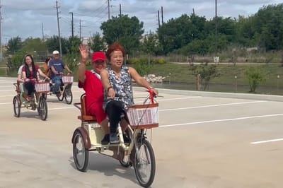 Residents enjoying a group bike ride outdoors