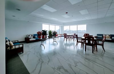 Bright common area with seating and large windows
