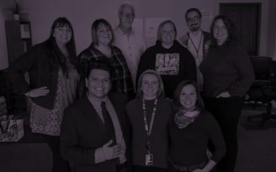 Group of staff members posing in an indoor setting